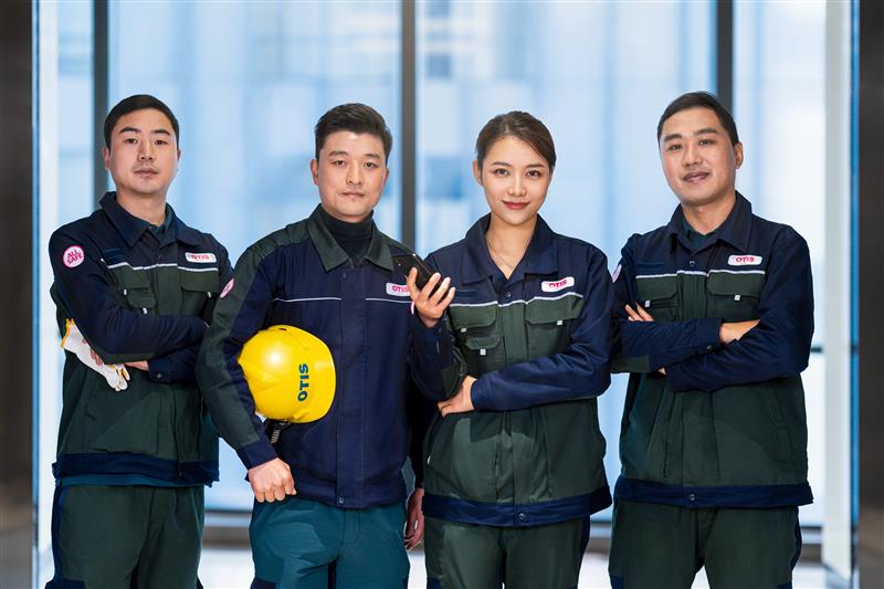 People Standing with Otis Uniform